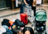 From Toddlers to Teens: Family Travel Tips by Age Group Personal chaotic airport/family moment with parent perspective, slightly off-center and candid, showing tired smiles amid mess.