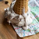 Italy Travel Tips: Eat, Explore & Experience Like a Local Low, candid angle of gelato drip and crumpled map, personal phone-snap feel with accidental framing errors.