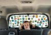 Traveling with Kids? These Family Travel Blogs Are Lifesavers a parent scrolling on a phone in a messy minivan backseat with kids' snacks spilled, a crumpled map,