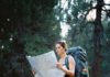Planning Your First Solo Adventure? Here’s a Complete Guide Consider these elements: a solo hiker pausing mid-trail with a slightly oversized backpack and a crumpled national park map in hand,